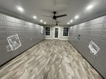 a large room with a ceiling fan and lockers